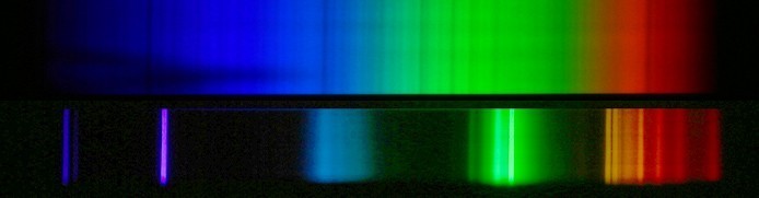 Top: The nearly continuous spectrum of the Sun. Bottom: The bright line spectrum of a compact florescent light. Credit: John P. Beale